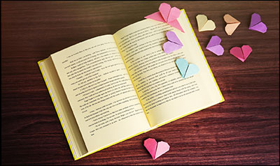 open book with paper hearts on it