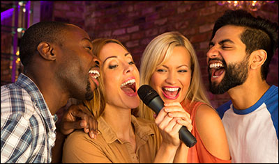 four people singing karaoke
