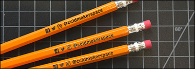 Three pencils with @ccldmakerspace engraved next to Facebook, Twitter, and Instagram icons.